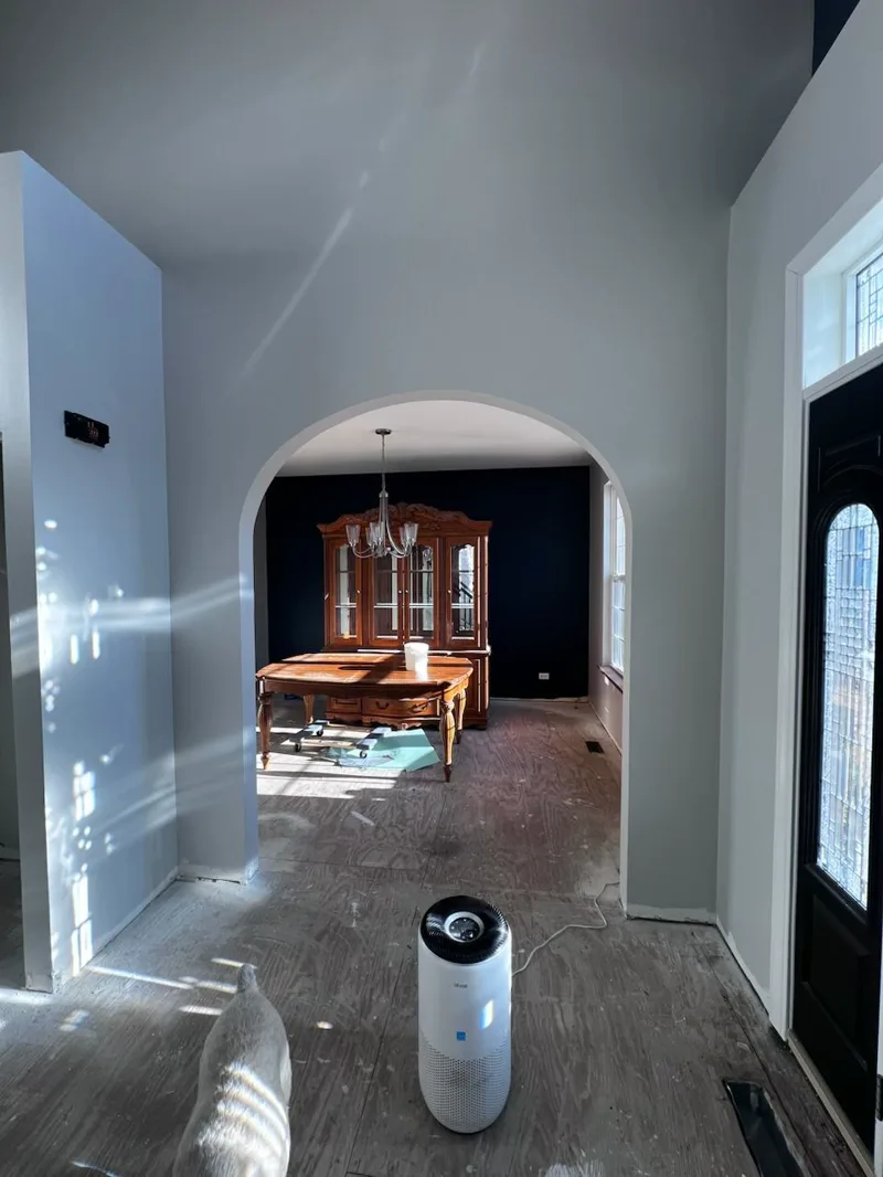 Dark navy wall finished above light flooring